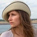 Refined ladies' hat with asymmetrical, turned-up brim made of fine velour felt. Handmade, extravagant derby hat in purist design, Sofia