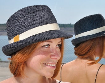 Summery,lightweight trilby made of braided paper yarn, with small symmetrical hat brim in elegant design and color accented hatband.Marcello