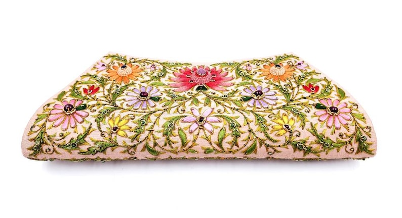 May include: A pink clutch purse with a floral design. The flowers are embroidered with colorful beads and sequins.