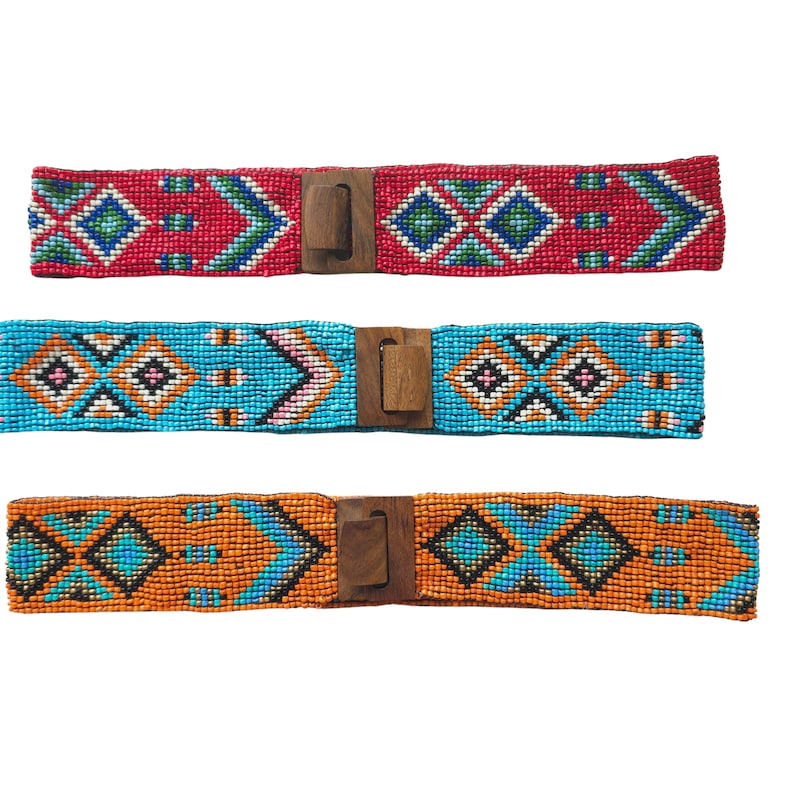 May include: Three beaded belts with wooden buckles. The belts are red, blue, and orange with geometric patterns.