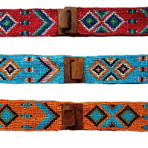 May include: Three beaded belts with wooden buckles. The belts feature geometric patterns in red, blue, and orange.