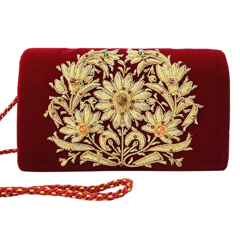 burgundy and gold clutch bag