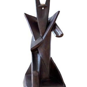 May include: Abstract bronze sculpture with a geometric design. The sculpture is made up of several intersecting planes and has a dark brown patina.