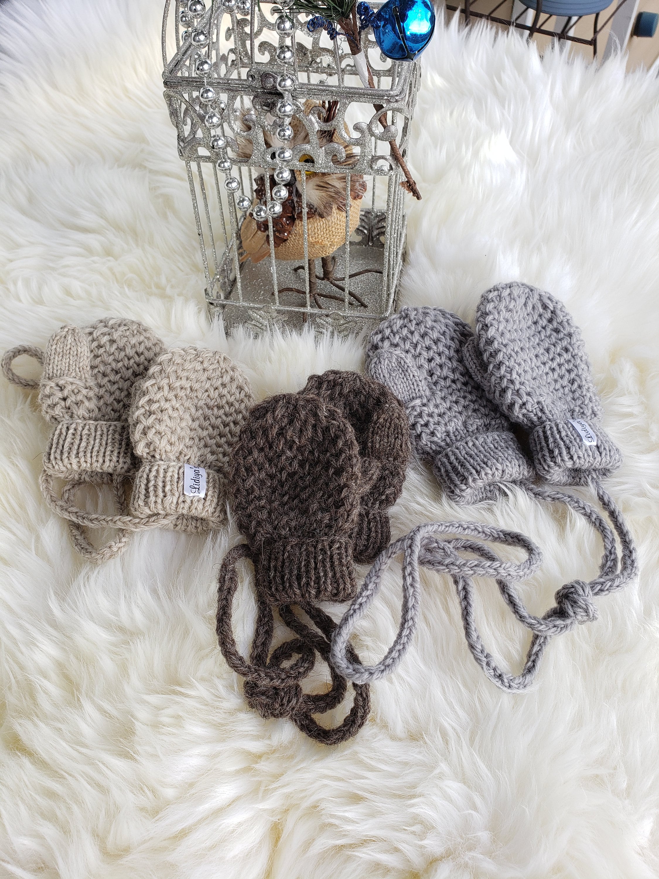 Infant mittens with string outlet