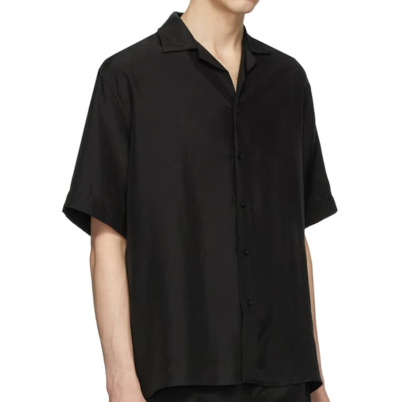 May include: A black short-sleeved button-down shirt with a collar.