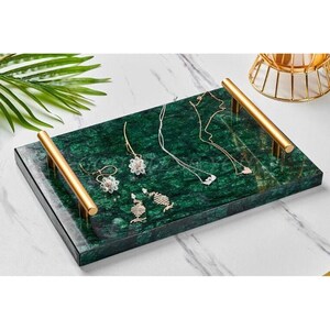 May include: A green marble tray with gold handles and a variety of jewellery pieces, including necklaces and earrings.