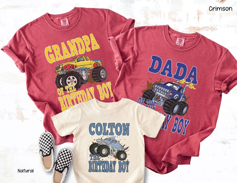 May include: Crimson and natural-colored t-shirts with monster truck graphics. One shirt says "Grandpa of the Birthday Boy," another says "Dada of the Birthday Boy," and the third says "Colton the Birthday Boy."