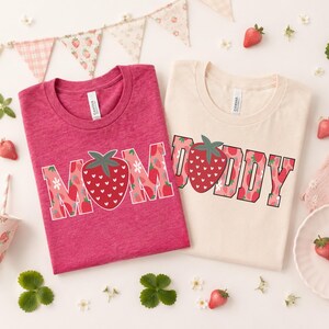 Celebrate family style with this sweet strawberry matching shirt set featuring bold DAD and MOM designs filled with playful strawberry patterns. This fruity family look is perfect for strawberry birthday parties, summer photos, parent matching outfits, family vacations, and coordinated celebration days. The mix of rich berry tones, floral strawberry details, and playful block lettering gives the shirts a cheerful, fun, and seasonal feel that works beautifully for moms and dads who love matching.