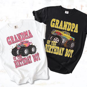 May include: Two t-shirts, one white and one black, with monster truck graphics. The white shirt says "Grandma of the Birthday Boy" with a pink monster truck. The black shirt says "Grandpa of the Birthday Boy" with a yellow monster truck.
