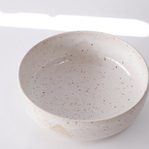 white speckled low bowl white matte glaze overlapping gloss glaze creating a subtle geometric pattern