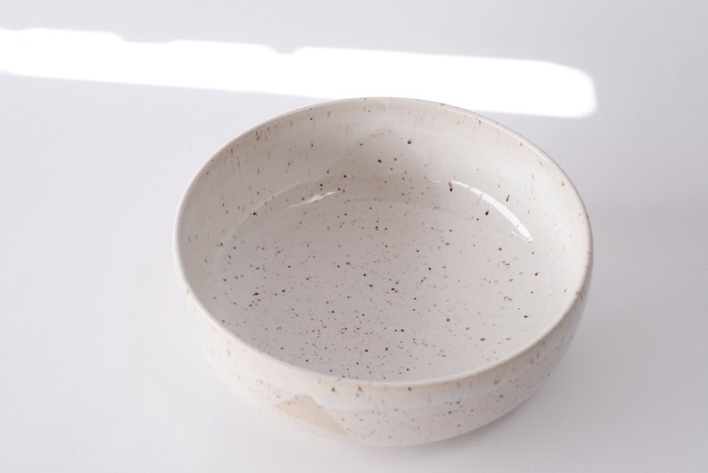 white speckled low bowl white matte glaze overlapping gloss glaze creating a subtle geometric pattern