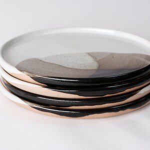 handmade stoneware dinner plate, two tone warm black and white glazes overlapping creating a gradient of warm earthy grays in between.