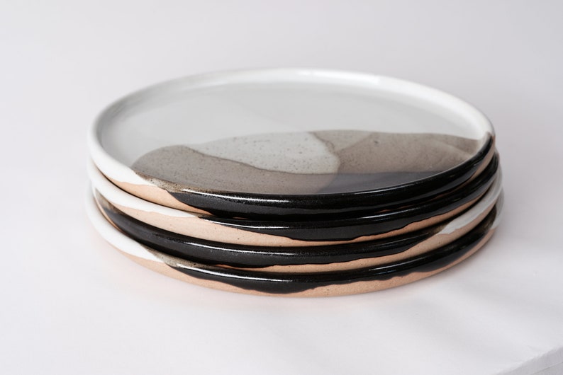 handmade stoneware dinner plate, two tone warm black and white glazes overlapping creating a gradient of warm earthy grays in between.