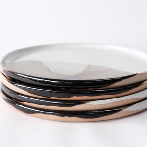 handmade stoneware dinner plate, two tone warm black and white glazes overlapping creating a gradient of warm earthy grays in between.