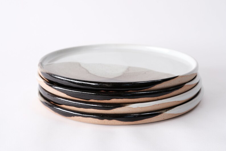 handmade stoneware dinner plate, two tone warm black and white glazes overlapping creating a gradient of warm earthy grays in between.