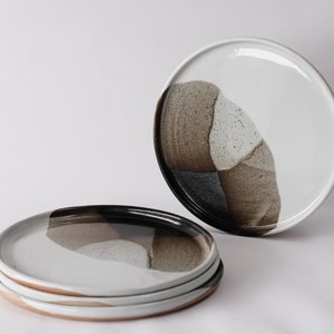handmade stoneware dinner plate, two tone warm black and white glazes overlapping creating a gradient of warm earthy grays in between.