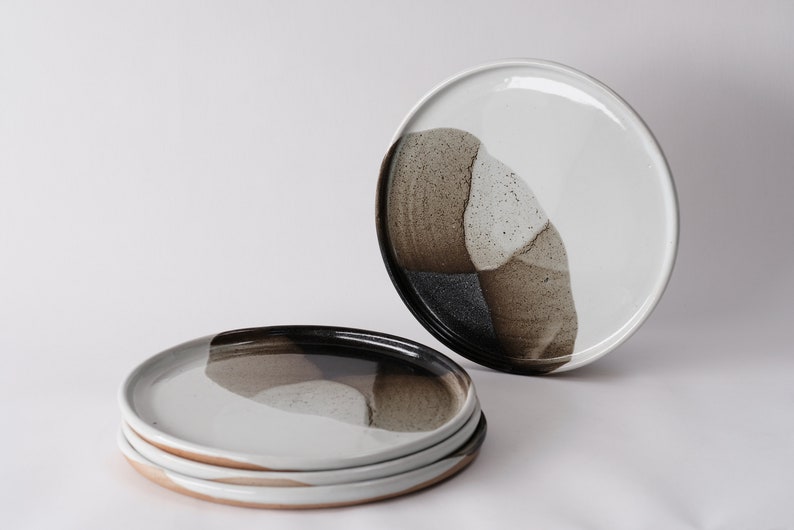 handmade stoneware dinner plate, two tone warm black and white glazes overlapping creating a gradient of warm earthy grays in between.