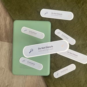 May include: A set of eight white stickers with a magnifying glass icon and the text "Do Not Disturb" with a checkmark. One sticker has the additional text "busy solving a case".