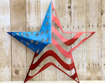 May include: A red, white, and blue metal star with a cutout design of the American flag. The star is made of metal and has a shiny finish.