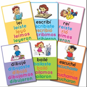 May include: Colorful flashcards with illustrations and Spanish verb conjugations. The verbs include "leer" (to read), "escribir" (to write), "reír" (to laugh), "bailar" (to dance), and "escuchar" (to listen).