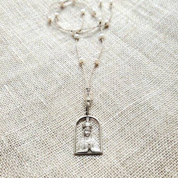 Antique Virgin Mary silhouette charm necklace .