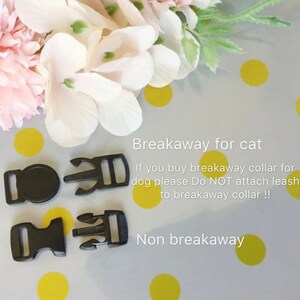 May include: Two types of black plastic clasps for collars. The top two clasps are breakaway for cats. The bottom two clasps are non-breakaway. Text reads: "Breakaway for cat. If you buy breakaway collar for dog please Do NOT attach leash to breakaway collar!! Non breakaway."