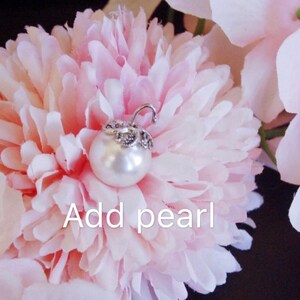 May include: A close-up of a pink flower with a pearl attached to the center. The text "Add pearl" is written below the flower.