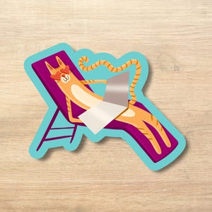 May include: A sticker featuring a cartoon cat relaxing in a purple and teal lounge chair, wearing heart-shaped sunglasses and reading a newspaper. The cat is orange with brown stripes. The sticker has a teal border.