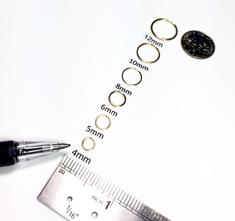 Six 14k gold filled endless hoops lined up in descending sizes from 12mm, 10mm, 8mm, 6mm, 5mm and 4mm laid out above ruler and next to dime.