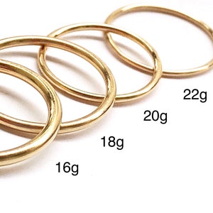 Four Class X 14k gold filled piercing hoop rings in various gauges including thin 22g, standard 20g, thicker 18g and thick 16g options on white background.