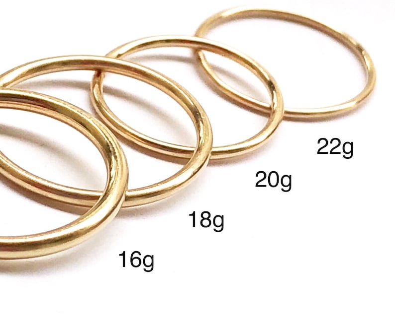 Four Class X 14k gold filled piercing hoop rings in various gauges including thin 22g, standard 20g, thicker 18g and thick 16g options on white background.