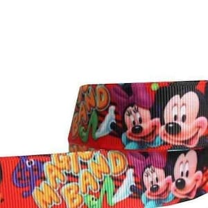 May include: Red ribbon featuring Mickey and Minnie Mouse with the words "MAD BAD" in green and yellow. The ribbon has a black background with the cartoon characters. The ribbon is suitable for crafting and gift wrapping.