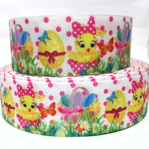 May include: White ribbon with a pink polka dot pattern and a repeating design of yellow chicks holding baskets of colorful Easter eggs. The chicks are wearing pink bows with white polka dots.