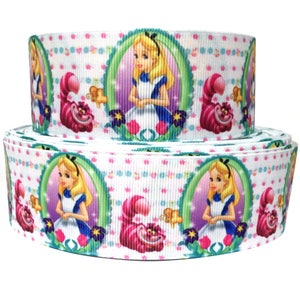 May include: White ribbon with a repeating pattern of Alice in Wonderland characters. Alice is depicted in a blue dress with a white apron, and the Cheshire Cat is shown with a pink and purple body. The background is white with pink and blue polka dots.