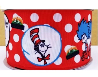 May include: A roll of red ribbon with white polka dots and illustrations of characters from a children's book. The ribbon features the Cat in the Hat and Thing 1 and Thing 2.