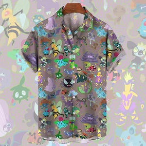 May include: Short-sleeved button-down shirt with a brown background and a repeating pattern of colorful cartoon characters. The shirt has a classic collar and is made of a lightweight fabric.