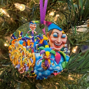 May include: A round Christmas ornament featuring a colorful image of a Mardi Gras parade with jester figures and a festive atmosphere.