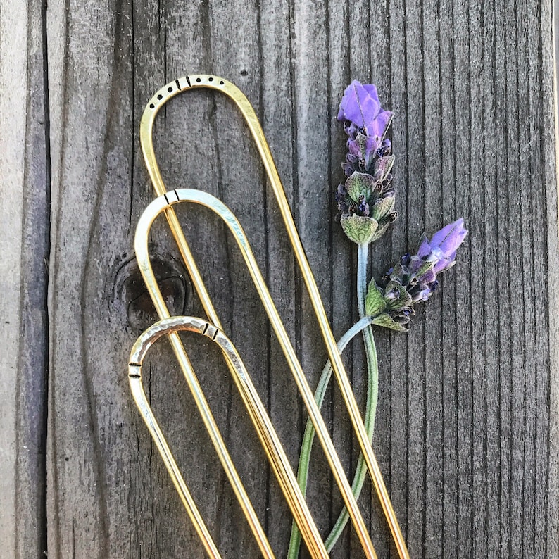 Brass hairpins in different stamped designs.