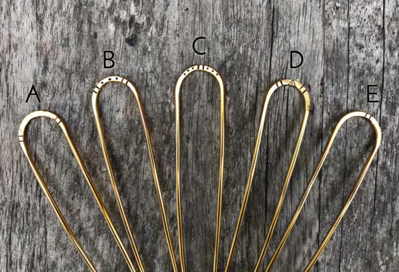 Brass hairpins in different stamped designs.