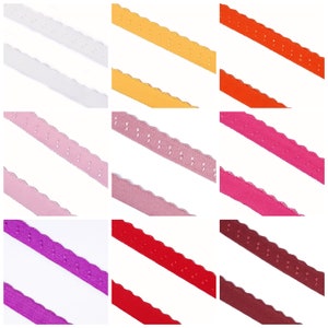 Könnte beinhalten: Neun verschiedene Farben von gewelltem Besatz mit einem gepunkteten Muster. Die Farben sind Weiß, Gelb, Orange, Rosa, Hellrosa, Rot, Burgunder, Lila und Dunkelviolett.