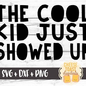 May include: Black and white text graphic on a white wood background. The text reads "The Cool Kid Just Showed Up".  The graphic is for a digital download of SVG, DXF, and PNG files.  The graphic is from Cheese Toast Digitals.