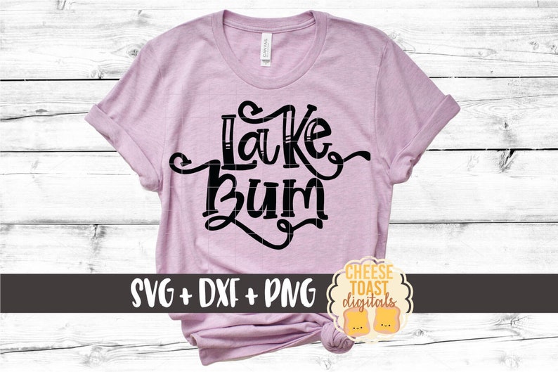 May include: A pink t-shirt with the text "Lake Bum" in black lettering. The shirt is on a white wood background. The text "SVG + DXF + PNG" is in the lower left corner of the image. The text "CHEESE TOAST digitals" is in the lower right corner of the image.