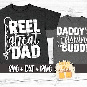 May include: Two gray t-shirts with white text. The larger shirt says "Reel Great Dad" with a fishing hook and line graphic. The smaller shirt says "Daddy's Fishing Buddy".