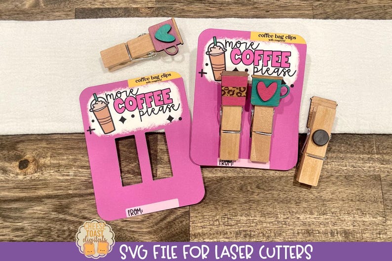 May include: Two pink and white cards with the text "more coffee please" and a coffee cup graphic. The cards are designed to be used as coffee bag clips. A wooden clothespin with a black circle is also shown.