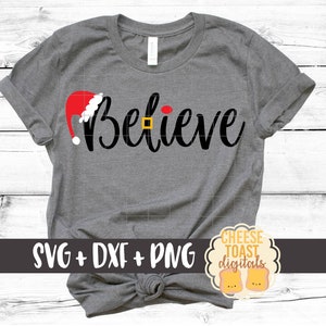 May include: Gray t-shirt with the word "Believe" in black script with a red Santa hat above the word. The shirt is tied in a knot at the bottom. The text "SVG + DXF + PNG" is at the bottom left of the shirt. A yellow circle with the text "CHEESE TOAST digitals" is at the bottom right of the shirt.