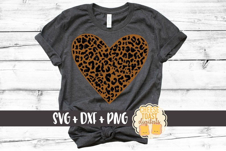 May include: A gray t-shirt with a brown and black leopard print heart design. The text "SVG + DXF + PNG" and "CHEESE TOAST digitals" is printed on the shirt.