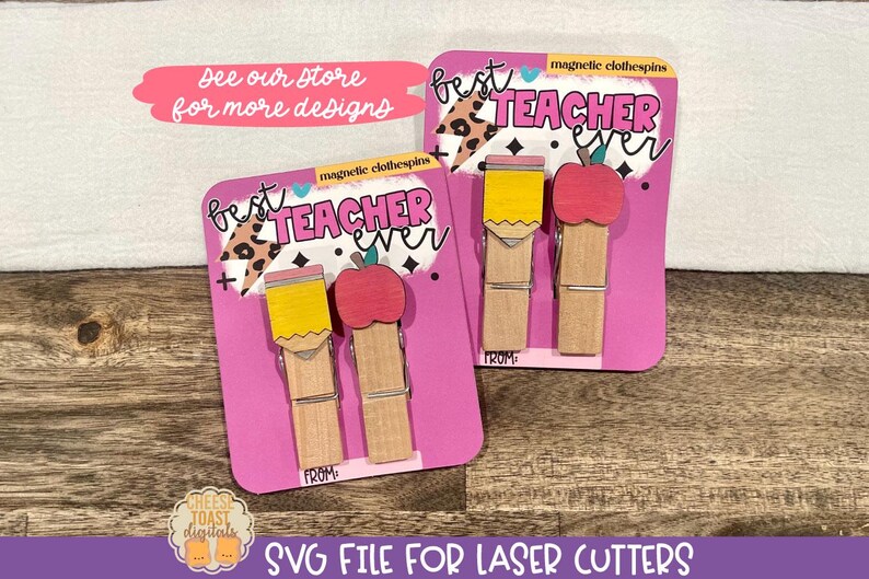 May include: Two pink cards with the text "Best Teacher Ever" and a pencil and apple design. The cards are for magnetic clothespins. The text "See our store for more designs" is on a pink banner at the top of the image.