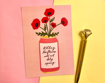 May include: A pink postcard with a red can design holding red poppies and green leaves. The can has a white label with the text "Killing the flowers will not delay spring." A gold pen with a diamond-shaped top is on the right.