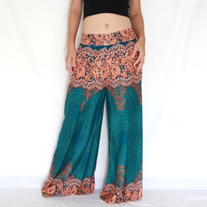 May include: Teal and orange printed wide-leg pants with a floral pattern. The pants have an elastic waistband and a flowing silhouette.