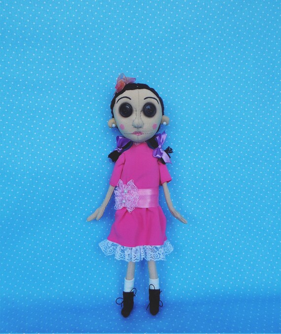 doll with pink hair and button eyes